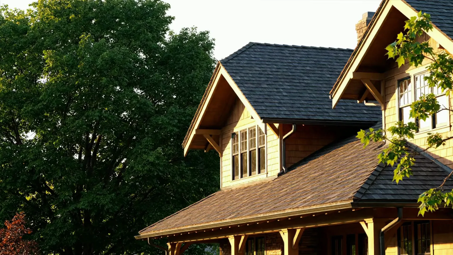 A craftsman home with charcoal architectural shingles in warm afternoon light